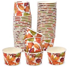 a bunch of plates and cups with autumn leaves on them, all in different colors