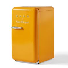 an orange refrigerator with the word smeg on it's front and bottom door