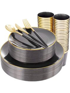 a stack of black and gold plates with forks