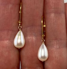 I just love this pearl shape and try to keep some in stock.  They flatter everyone.  This is a teardrop shaped freshwater pearl dangle earring on gold-filled lever backs.  The pearls are nicely matched, white to ivory in color with a nice skin.  They have the occasional line or dimple, but overall are very clean with a bright luster.  The pearls measure 6.5-7mm in diameter and 9-11mm in length.  Total earring length is 1 1/8" with a drop length of 1/2". These come gift boxed and ship free USPS First Class.  If you'd like faster shipping you can upgrade to Priority Shipping at checkout for $5.50. Thank you for viewing. Tear Drop Pearl Earrings, Oval High Luster Pearl Earrings For Formal Events, Formal High Luster Oval Pearl Earrings, Elegant Oval Pearl Earrings With High Luster, High Luster Drop Pearl Earrings For Anniversary, Classic High Luster Drop Pearl Earrings, Classic Oval High Luster Pearl Earrings, Oval Pearl Earrings For Gifts, High Luster Teardrop Pearl Earrings