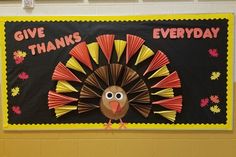 a bulletin board with a turkey on it that says give thanks everyday and is decorated