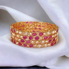 Ruby Polki bangle set of 4 bangles. This beautiful Reverse AD Polki bangles are made up of brass with 18 k gold finish.   All orders Ship same day if placed before 4:00 PM EST  Create beautiful memory for any occasion with elegant jewelry for your loved ones We will be happy to navigate you through the process so if you have any questions regarding our product before placing an order reach out to us and we will be there to help you.  Thank you for your visit and support Pink Cutdana Bracelets For Festivals, Festive Pink Cutdana Bracelets, Party Jewelry Bangle With Zari Work, Bollywood Style Bracelets With Zari Work For Parties, Bollywood Zari Work Bracelets For Party, Traditional Pink Bangle For Festive Occasions, Pink Bollywood Bangle For Festivals, Traditional Pink Bangle For Festive Season, Pink Cutdana Bangle For Diwali