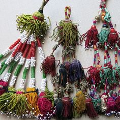 several different types of beaded necklaces laid out on a table