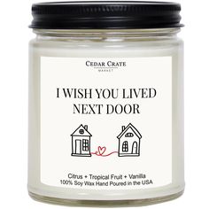 a white candle that says i wish you lived next door