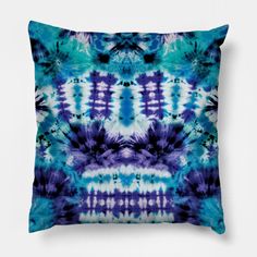 a blue and purple tie dye pillow on a white background