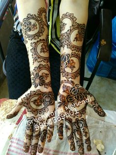 two hands with henna designs on them