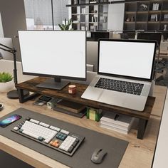 two computer monitors sitting on top of a wooden desk