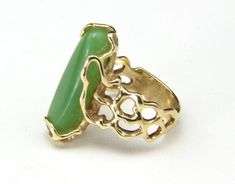 "Vintage 14k Jade Ring -Artisan, freeform modern design -Marked \"14k\" yellow gold -Beautiful bright green oblong jade stone -Ring is size 6 -Surface measures .9\" x .3\" -Depth of the ring measures .26\" -Band width .2\" -Weight 8.5g In very good vintage condition, band is beautiful with no apparent scratches, ready to wear!" Modern Oval Green Jewelry, Modern Green Cabochon Rings, Modern Green Cabochon Jewelry, Modernist Green Jewelry For Gifts, Modernist Green Ring As A Gift, Modernist Green Ring For Gift, Green Modernist Ring As A Gift, Modernist Green Rings For Gift, Green Modernist Ring As Gift