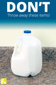 a white jug sitting on top of a counter next to a blue and white sign