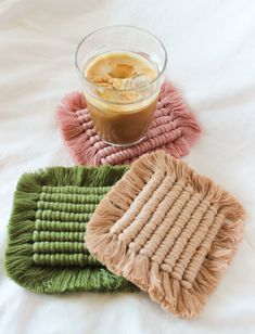 three mop pads sitting on top of a bed next to a cup of liquid