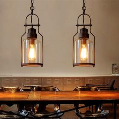 two light fixtures hanging over a wooden table