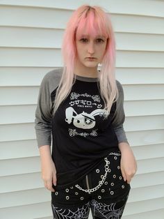 "Important Announcement!!  We will be overhauling our brand in the new year and many designs will be retired! Be sure to grab any favorites now before they are gone! Our adorably badass Jrock Bunny is rocking his visual kei style on this raglan tee. These two-color unisex raglan shirts are made of a lightweight, buttery-soft polyester/cotton blend, and are amazingly comfortable! The 3/4 length sleeves hit just below the elbow, with contrast color sleeves for a stylish colorblock look. ☆ For more Punk Style Tops With Anime Print For Cosplay, Harajuku Style Graphic Print Top For Alternative Fashion, Punk Anime Print Halloween Top, Harajuku Anime Print Tops For Alternative Fashion, Harajuku Long Sleeve Tops For Alternative Fashion, Emo Anime Print Tops For Streetwear, Punk Halloween Anime Print Top, Halloween Punk Anime Print Tops, Edgy Cotton Tops For Cosplay