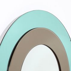 a circular mirror is shown against a white wall and has blue trim around the edges