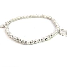 Authentic Tiffany & Co Estate Ball Bracelet 7" Silver 4 mm TIF525This elegant Authentic Tiffany & Co bracelet is made of sterling silver and has a weight of 5.5 grams.TRUSTED SELLER SINCE 2002PLEASE SEE OUR HUNDREDS OF POSITIVE FEEDBACKS FROM OUR CLIENTS!!FREE SHIPPING!!DETAILSStyle: Ball BraceletLength: 7 InchesSize: 4 mmWeight: 5.5 GramsMetal: Sterling SilverWe try to present our Tiffany estate items as best as possible and most have been newly polished some of the Tiffany items may have a nat Tiffany & Co. Bracelet, Sterling Silver Bracelets Women Tiffany & Co., Elegant Bracelet Tiffany & Co., Classic Beaded Bracelets With Sterling Silver Clasp As Gift, Classic Sterling Silver Charm Bracelet Hallmarked, Classic White Gold Sterling Silver Charm Bracelet, Classic Charm Bracelet With Sterling Silver Clasp, Classic Silver Beaded Bracelet Gift, Classic Sterling Silver Bracelet With Round Beads For Gifts