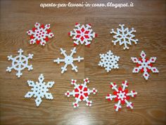 six snowflakes made out of plastic beads