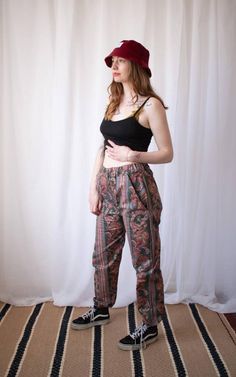 High Waisted Paisley Trousers These absolutely gorgeous trousers have been handmade using recycled material, the print is intricate flowers with paisley designs influenced through out, with earthy colours, bold patterns and a comfy fit. The make the perfect pair of trousers for keeping snug and funky throughout the Autumn months or for jazzing up a festival look. There's only three trousers available, meaning they are completely limited edition.UK size 8UK size 10UK size 12/14Inside Leg 28" I of Hippie Trousers, Festival Trousers, Black Mesh Crop Top, Trousers High Waisted, Paisley Pants, Floral Trousers, Earthy Colours, Festival Pants, Earthy Outfits