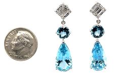 These exquisitely handcrafted aquamarine and diamond earrings definitely say "special occasion,” or more importantly, "special lady!” The pear-shaped aquamarines weigh 10.50 carats total and are extremely brilliant, with beautiful medium-blue color that is characteristic of superfine, gem-quality aquamarine. The round aquamarine are from the Santa Maria aquamarine mine, famous for its recognizably darker shades. Paired with sparkling baguette and round diamonds that give these earrings a sophisticated yet contemporary feel, the high-fashion look of these statement earrings are sure to turn heads! The earrings measure 1-3/8" in length and were custom-crafted by hand in 18k white gold by our Master Jewelers in Los Angeles. Pear-shaped aquamarines, 16.40 x 8.80mm, 10.50 carats total Round aqu High Fashion Looks, Diamond Dangle Earrings, Aquamarine Jewelry, Jewellery Earrings, Ruby Sapphire, Ring Pendant Necklace, Shades Of Orange, Fine Jewellery Earrings, Santa Maria