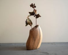 a wooden vase with some flowers in it