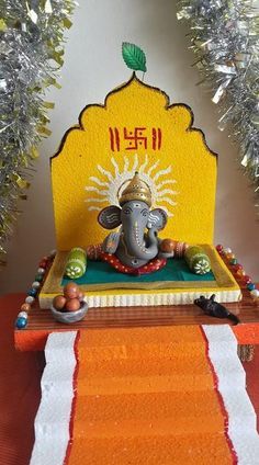 an elephant statue sitting on top of a table next to a red and white runner