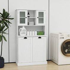 a washer, dryer and cabinet in a room