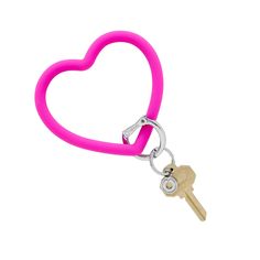 a pink heart shaped keychain with two keys attached to the front of it