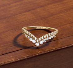 a diamond ring sitting on top of a wooden table