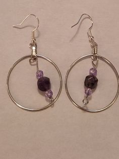 Amethyst faceted beads, lavender faceted beads, dangle from a stainless steel hoop, on stainless steel hooks. I enjoy working with my February birthstone, so I hope you will like them too. Adjustable Metal Earrings With Faceted Beads, Small Hoop Beaded Earrings With Faceted Beads For Gift, Purple Metal Crystal Earrings As Gift, Purple Crystal Metal Earrings For Gifts, Purple Metal Crystal Earrings For Gift, Gift Small Hoop Beaded Earrings With Faceted Beads, Metal Beaded Earrings With Faceted Beads For Gifts, Nickel-free Purple Dangle Hoop Earrings, Purple Dangle Hoop Earrings With Ear Wire