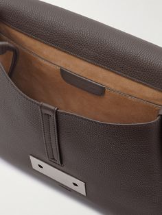 Berluti's leather goods are built to last and age beautifully. This 'Spirale' messenger bag is made from full-grain leather that'll resist wear and tear and has a suede underside to protect your essentials. The ornamental clasp on the front is a celebration of the house's initial. Designer Calf Leather Shoulder Bag With Leather Backing, Business Flap Satchel In Textured Leather, Leather Satchel With Magnetic Closure, Leather Saddle Bag With Magnetic Closure For Travel, Designer Brown Leather Flap Bag, Business Textured Leather Satchel Flap Bag, Rectangular Leather Saddle Bag With Magnetic Closure, Designer Leather Flap Bag For Business, Brown Leather Satchel With Magnetic Closure