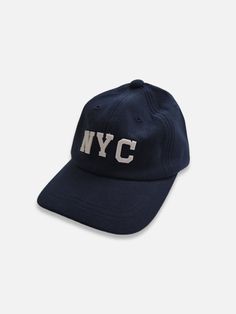 Baseball cap featuring NYC embroidering and strap back with belt buckle. Navy Baseball Cap With Logo Patch, Navy Baseball Cap With Logo Patch And Curved Bill, Navy Baseball Cap With Embroidered Logo, Navy Six-panel Baseball Cap With Logo Patch, Classic Adjustable Snapback Hat With Embroidered Logo, Navy Snapback Baseball Cap With Embroidered Logo, Navy Embroidered Logo Snapback Baseball Cap, Urban Six-panel Baseball Cap With Embroidered Logo, Urban Embroidered Logo Six-panel Baseball Cap