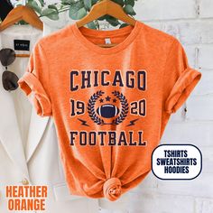 Please Note: This listing contains multiple shirt types. To insure you are getting the item you expect, please review all options and photos carefully before ordering. Our Chicago Football Apparel is the perfect way to cheer on your team this season. Choose from short sleeve tees, sweatshirts or hoodies. Makes a great gift for any fan. Perfect for game day, tailgates or everyday wear.  SHIRT DETAILS Bella Canvas Unisex - Solid colors: 100% Cotton. - Heather colors: 52% Cotton + 48% Polyester - Runs true to size. (For looser or oversized fit consider going up a size or 2. See photos for size chart.) SWEATSHIRT & HOODIE DETAILS Gildan Heavy Blend Unisex - 50% Cotton + 50 Polyester - Runs true to size. (For looser or oversized fit consider going up a size or 2. See photos for size chart.) CAR Fall Sports T-shirt With Letter Print, Orange Sporty Crew Neck Hoodie, Orange Crew Neck Sporty Hoodie, Sporty Screen Print T-shirt For Fall, Winter College T-shirt With Screen Print, Orange Crew Neck Top For Sports Season, Orange Letter Print Crew Neck Hoodie, Team Spirit Sports T-shirt For Fall, Fall Varsity Sports T-shirt