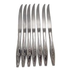 six knives are lined up next to each other