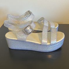 Iridescent/Rainbow Sparkle Jelly Shoes/ Sandals. Made By Aldo, Basically Brand New, Only Worn A Few Times. No Scuffs Or Scratches. Glitter Round Toe Jelly Sandals For Party, Glitter Jelly Sandals With Round Toe For Summer, Glitter Ankle Strap Sandals For Summer, Glitter Jelly Sandals For Summer, Summer Glitter Ankle Strap Sandals, Summer Glitter Jelly Sandals With Round Toe, Iridescent Round Toe Synthetic Heels, Iridescent Synthetic Heels With Round Toe, Adjustable Synthetic Jelly Sandals For Party