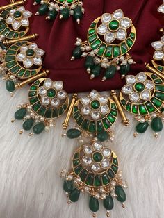 Jadau Kundan Green Floral Necklace with matching EarringsColor : GoldenSize : Necklae Length : 16 Inches; Earrings Length : 1.5 InchesStones : Jadau Kundan Pearls Kundan Bridal Necklace With Matching Earrings In Temple Style, Traditional Round Kundan Necklace With Stones, Festive Green Bridal Necklace With Stone Setting, Traditional Festival Earrings With Stones, Traditional Round Bridal Necklace With Stones, Green Kundan Necklace With Stone Setting In Temple Style, Round Kundan Necklace With Stones For Celebration, Green Kundan Necklace For Ceremonial Occasion, Temple Style Green Kundan Necklace With Stone Setting