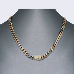 Welcome to our luxurious e-commerce store, where we offer the most stylish and eye-catching jewelry pieces. Our latest addition is the 14K Tri-Colors Iced Out Flooded Cuban Chain Set, a must-have for any fashion-forward individual. Made with 14K gold, this set exudes elegance and sophistication.The necklace measures 18 inches in length and has a thickness of 7mm, making it the perfect statement piece to elevate any outfit. The bracelet, with a length of 7.5 inches and a thickness of 6mm, complements the necklace beautifully, creating a cohesive and stunning look.This set is perfect for those who love to make a bold fashion statement. The tri-color design adds a unique touch, while the iced out detailing adds a touch of sparkle and glamour. Whether you're dressing up for a special occasion Elegant Multicolor Jewelry With Chain, Elegant Multicolor Adjustable Chain Necklace, Gold Iced Out Chain Link Necklace, Multicolor Chain Bracelet Jewelry, Multicolor Chain Bracelet, Gold Iced Out Metal Chain Necklace, Multicolor Link Chain Jewelry, Gold Iced-out Cuban Link Necklace, Luxury Gold-plated Cuban Link Necklace