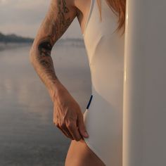 Details Introducing the Boa One Piece - the perfect one piece swimsuit for surfers seeking comfort and style. With its built-in bra, this cleverly designed piece provides exceptional breast support while keeping you fashion-forward. Say goodbye to uncomfortable swimwear and hello to confidence! The Boa One Piece features flattering lines that accentuate your natural curves, making it a timeless and elegant choice for any occasion. Whether you're lounging by the pool or catching waves, this swims Compressive Swimwear With Built-in Bra For Beach, White Stretch Surfing Bodysuit, White One-piece Swimwear For Surfing, White Compressive Swimwear For Summer, Sporty Fitted Swimwear For Surfing, White Beachwear Bodysuit For Surfing, Summer Nylon Bodysuit For Surfing, Nylon Bodysuit For Surfing In Summer, Fitted Beachwear Bodysuit For Water Sports