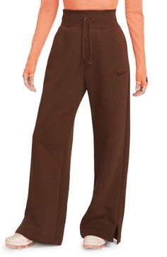 Get incredibly comfy in these wide-leg sweats with split hems so you can show off your favorite footwear. Taller ribbing at the waist, as well as an exaggerated drawcord, ensure the look is anything but basic. 28" inseam; 12" front rise (size Small) 80% cotton, 20% polyester Machine wash, tumble dry Imported Trendy Wide Leg Sweatpants For Fall, Casual Wide Leg Sweatpants For Fall, Trendy Straight Leg Sweatpants For Fall, Brown Wide Leg Sweatpants For Fall, Brown Wide-leg Sweatpants For Fall, Fall Loungewear Wide-leg Sweatpants, Cozy Nike Sweats, Sporty Cotton Wide Leg Pants For Fall, Wide Leg Brown Sweatpants For Winter