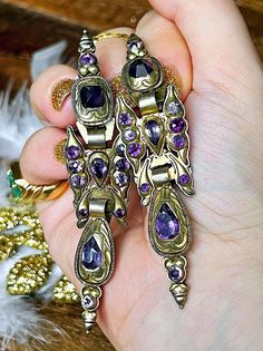 Antique Iberian Catalan earrings from 1790-1810.  They are mounted on silver gilt.  Gilding testing 12ct gold. Also they are set with beautiful amethysts with amazing vibrant colors (fully tested)! 8.8cm long, 19gr altogether and they can be worn in two ways taking out the butterfly part. That would make the earring much simpler and easy to wear. These earrings were anciently marriage tokens. The first was given at the promise and the second after the marriage, so wearing both meant you were mar Victorian Style Ceremonial Earrings For Pierced Ears, Antique Ceremonial Dangle Earrings, Antique Ceremonial Earrings For Pierced Ears, Antique Dangle Earrings For Ceremonies, Antique Earrings With 17 Jewels For Ceremonial Occasions, Victorian Pierced Jewelry For Ceremonial Occasions, Victorian Brass Earrings For Ceremonial Use, Victorian Brass Earrings For Ceremonial Occasions, Victorian Style Ceremonial Dangle Earrings