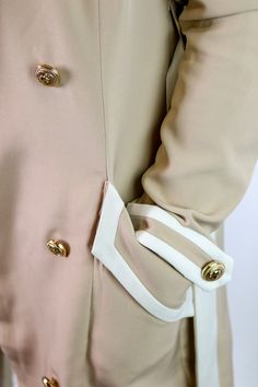 Elegance is the name of the game and the Olivia double-breasted trench coat is the winner! Framed with a dramatic collared neck with notched lapels and long sleeves, the self-tie cinching waist belt defines the look ever-so-gently. Twin flap pockets at the front not only add style but are also perfect for purse-free days. Wooven trench coat Notched, lapel winged collar with white contrast Double breasted gold button front closure Belt loops with contrast self waist belt Hip flap pockets with con Wing Collar, Double Breasted Trench Coat, Free Day, The Winner, Gold Buttons, Waist Belt, Bra Sizes, Flap Pocket, The Game