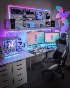 a desk with two computer monitors and a chair in front of it, all lit up by neon lights