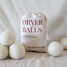 five balls of dryer balls sitting next to each other on a white cloth background