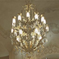 a chandelier hanging from the ceiling in a room with white walls and flooring