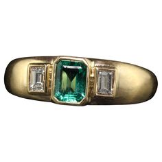 Beautiful Vintage Retro French 18K Yellow Gold Colombian Emerald Diamond Three Stone Ring. This gorgeous vintage French retro three stone ring is crafted in 18k yellow gold. The center holds a natural Colombian emerald and has two beautiful old cut diamond baguettes on the sides. The ring sits low on the finger and is in great condition. Item #R1882 Metal: 18K Yellow Gold Weight: 4.8 Grams  Size: 6 Emerald: Approximately .40 cts Side Diamonds: Approximately .25 ct Color: H Clarity: VS2 Measureme Emerald Engagement Ring Unique, Vintage Emerald Engagement Ring, Diamond Three Stone Ring, Emerald Ring Vintage, French Retro, Gold Ring Designs, Three Stone Ring, Colombian Emeralds, Band Engagement Ring