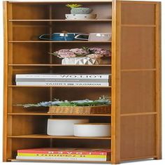 an open bookcase with books and flowers on it