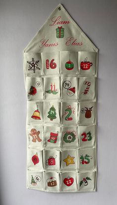 a white wall hanging with christmas decorations on it