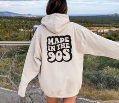 Made In The 90s - Oversized Retro Sweatshirt Hoodie Order 1-2 sizes larger for an oversized fit. This unisex heavy blend hooded sweatshirt is relaxation itself. Made with a thick blend of cotton and polyester, it feels plush, soft and warm, a perfect choice for any cold day. In the front, the spacious kangaroo pocket adds daily practicality while the hood's drawstring is the same color as the base sweater for extra style points. .: 50% cotton, 50% polyester .: Medium-heavy fabric (8.0 oz/yd² (27 90s Oversized Hooded Hoodie, Oversized 90s Cotton Hoodie, 90s Oversized Hoodie With Crew Neck, 90s Oversized Crew Neck Hoodie, 90s Style Oversized Crew Neck Hoodie, Retro Oversized Hoodie Sweatshirt, Large Retro Hoodie For Streetwear, Retro Winter Hoodie With Relaxed Fit, Retro Oversized Hoodie For Streetwear