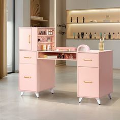 a pink desk with lots of bottles on it and shelves in the back ground behind it