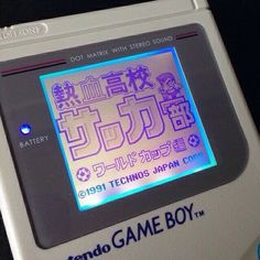 an old nintendo game boy with japanese characters on it