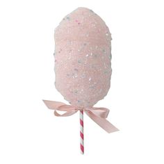 a pink lollipop with glitter on it and a striped candy bar in the middle