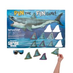 a shark game is being held up by someone's hand and it has several different shapes