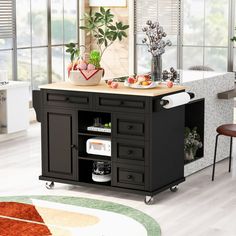 a kitchen island cart with cutting board on top